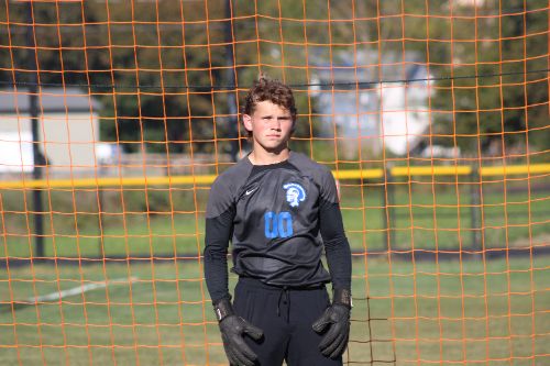 Student Athlete in goal in black uniform